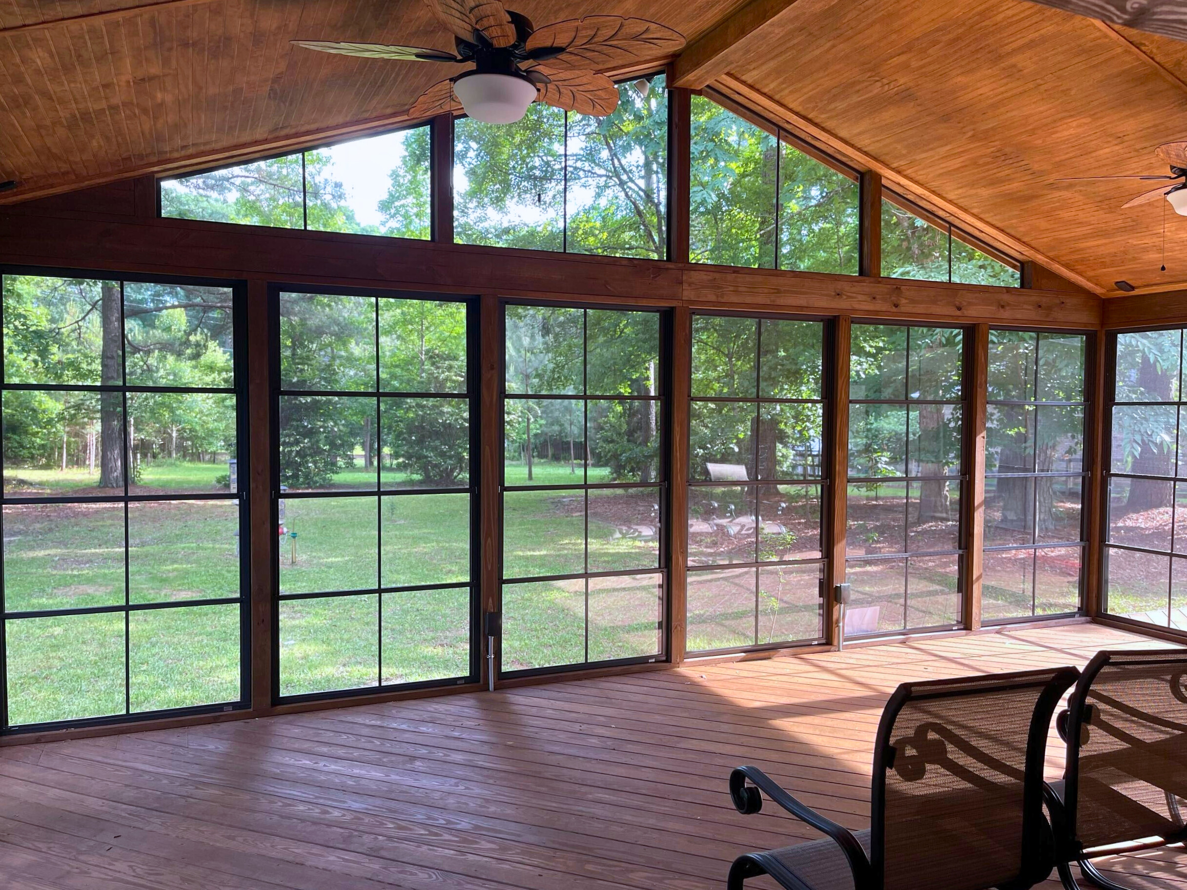 Inside a gorgeous sunroom in Charlotte with 4-track windows.